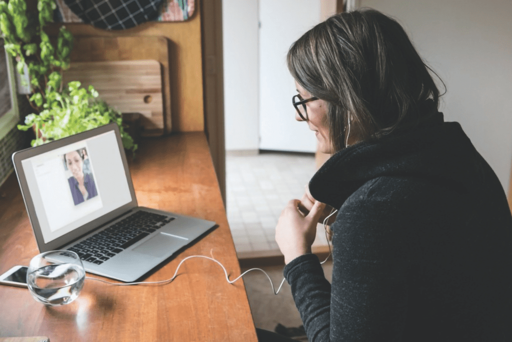 a therapist communicates with a client via a laptop