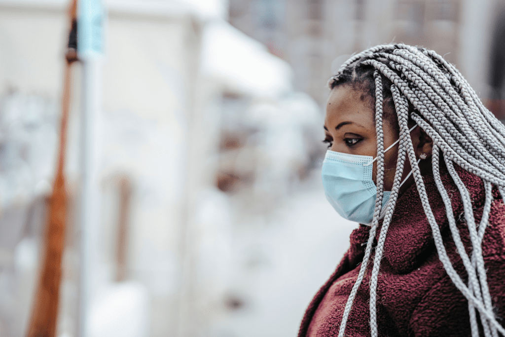 A masked-woman walks forward towards an uncertain future.