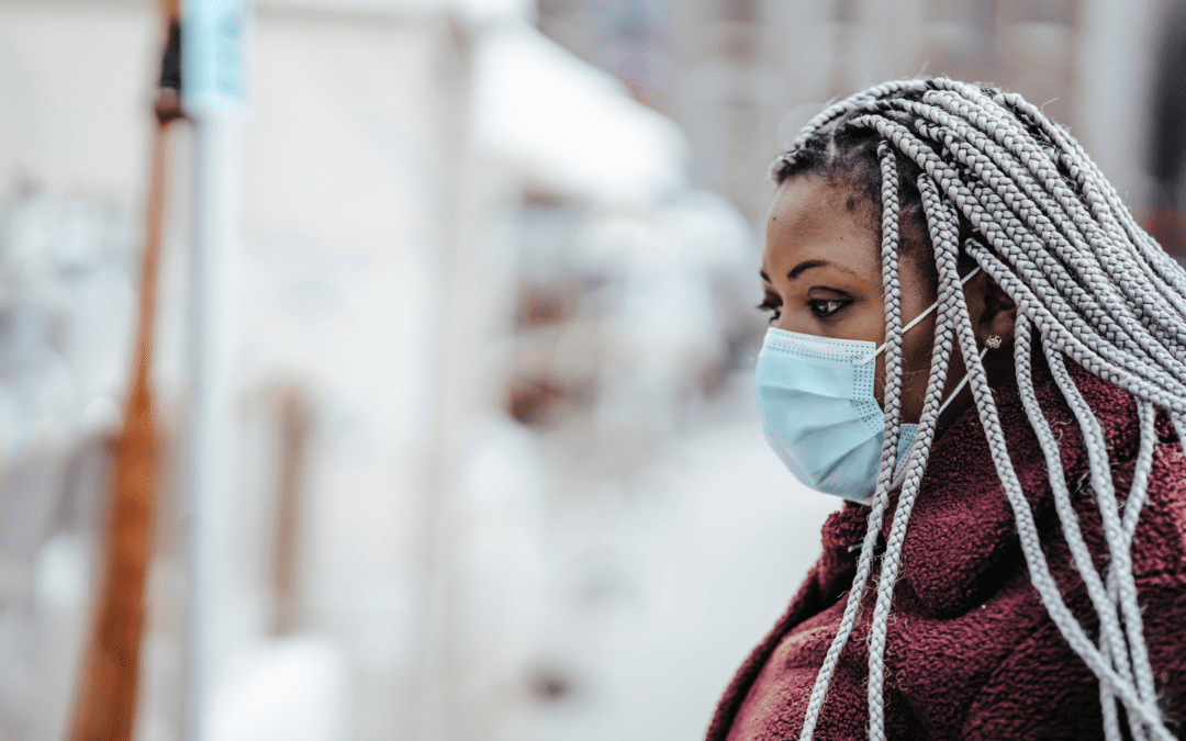 A masked-woman walks forward towards an uncertain future.