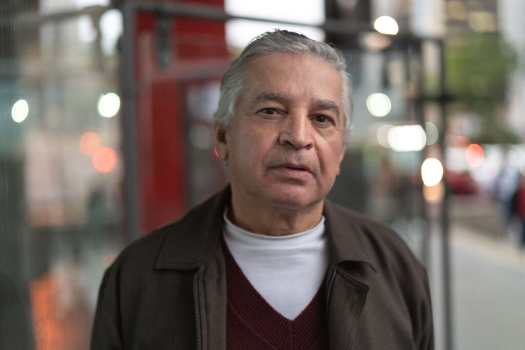 A man stands outside sharing the details of his recovery from gambling addiction