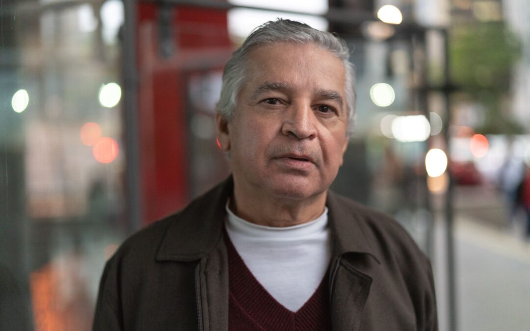 A man stands outside sharing the details of his recovery from gambling addiction